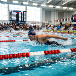 Swimmer performing butterfly stroke in a competitive swimming pool race